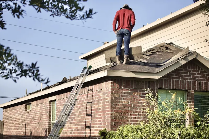 Professional roofer working on a residential roof in Home Acres